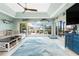 Waterfront living room with large sliding doors, light blue walls, and a ceiling fan at 158 Morgan Se Ln, Port Charlotte, FL 33952