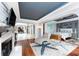 Open-concept living room with hardwood floors, statement fireplace, and seamless access to bedroom at 158 Morgan Se Ln, Port Charlotte, FL 33952