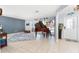 Spacious living room featuring a baby grand piano, tile floors, and an open layout at 158 Morgan Se Ln, Port Charlotte, FL 33952