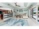 Living room with waterfront view, a neutral sofa, and an open kitchen area with bar seating at 158 Morgan Se Ln, Port Charlotte, FL 33952
