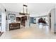 Bright living room with tile floors, stylish lighting, and views into the open kitchen at 158 Morgan Se Ln, Port Charlotte, FL 33952