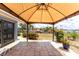 A covered patio with a tile floor that leads to a landscaped yard on a waterfront at 158 Morgan Se Ln, Port Charlotte, FL 33952