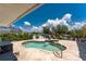 A kidney-shaped pool with lush landscaping and views of the waterway at 158 Morgan Se Ln, Port Charlotte, FL 33952