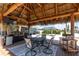 Outdoor dining area under a tiki hut, perfect for entertaining with built-in grilling area at 158 Morgan Se Ln, Port Charlotte, FL 33952