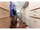 Large walk-in closet featuring hardwood floors, custom cabinetry, and ample storage space at 158 Morgan Se Ln, Port Charlotte, FL 33952