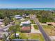 An aerial view of a charming home near the coast with mature trees and a spacious lot at 1585 Poinciana Rd, Venice, FL 34293