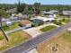 Aerial shot of the property featuring a fenced yard, detached garage, and a location near the open bay at 1585 Poinciana Rd, Venice, FL 34293