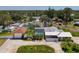 Aerial view showcasing the pool, metal roof house, and additional structure on the property at 1585 Poinciana Rd, Venice, FL 34293