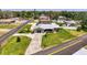 Aerial view of a single-Gathering home with a well-manicured lawn and long driveway at 1585 Poinciana Rd, Venice, FL 34293