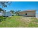 A spacious backyard features a storage shed, lush green grass and privacy fencing at 1585 Poinciana Rd, Venice, FL 34293