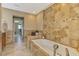 Elegant bathroom with a soaking tub surrounded by decorative tile work at 1585 Poinciana Rd, Venice, FL 34293
