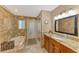 Bathroom features granite counters, wood cabinets, soaking tub and backyard access at 1585 Poinciana Rd, Venice, FL 34293