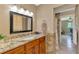 Bathroom with granite countertop, updated fixtures, and a large mirror at 1585 Poinciana Rd, Venice, FL 34293