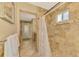 Shower features stylish tile work, seating, and lots of natural light at 1585 Poinciana Rd, Venice, FL 34293