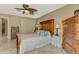 Comfortable bedroom featuring a wooden bed frame, bedside table, and neutral decor at 1585 Poinciana Rd, Venice, FL 34293