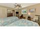 Inviting bedroom with two beds, ceiling fan, and ample natural light at 1585 Poinciana Rd, Venice, FL 34293