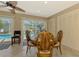 Charming dining area with pool views, tile flooring, and a modern ceiling fan at 1585 Poinciana Rd, Venice, FL 34293