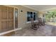 Inviting front porch featuring rocking chairs and stylish front door at 1585 Poinciana Rd, Venice, FL 34293