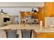 Spacious kitchen boasts a granite island with bar seating and stainless appliances overlooking living room at 1585 Poinciana Rd, Venice, FL 34293