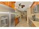 Updated kitchen showcasing stainless steel appliances and seamless flow into dining area at 1585 Poinciana Rd, Venice, FL 34293