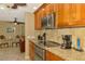 Close up of updated kitchen featuring granite countertops, stainless appliances, and custom wood cabinetry at 1585 Poinciana Rd, Venice, FL 34293