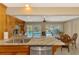 Kitchen featuring granite countertops, stainless appliances and view to pool and dining area at 1585 Poinciana Rd, Venice, FL 34293