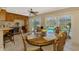 Bright eat-in kitchen with custom cabinetry, granite countertops, and sliding doors to the pool at 1585 Poinciana Rd, Venice, FL 34293