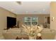Comfortable living room featuring neutral tones, recessed lighting, and view to the yard beyond at 1585 Poinciana Rd, Venice, FL 34293