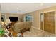 Cozy living room featuring tile floors, large windows, and ample seating at 1585 Poinciana Rd, Venice, FL 34293