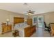Bright main bedroom with traditional furnishings and a sunny view of the pool at 1585 Poinciana Rd, Venice, FL 34293