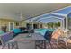 The covered patio features comfortable seating and a table, adjacent to the refreshing pool at 1585 Poinciana Rd, Venice, FL 34293