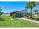 A backyard view showcases a screened-in pool and a meticulously landscaped garden at 1585 Poinciana Rd, Venice, FL 34293