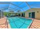 Home swimming pool in screened enclosure with brick paver deck at 1585 Poinciana Rd, Venice, FL 34293