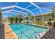 Home swimming pool in screened enclosure with brick paver deck and basketball hoop at 1585 Poinciana Rd, Venice, FL 34293