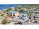 Wide aerial view of waterfront home, with mature landscaping and neighborhood features at 17 Southwind Dr, Englewood, FL 34223