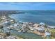 Aerial view of waterfront community with houses on canal leading to the ocean at 17 Southwind Dr, Englewood, FL 34223