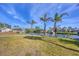 Well maintained waterfront backyard with mature palms and canal access at 17 Southwind Dr, Englewood, FL 34223
