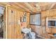 Cozy bathroom with a wood paneled wall and ceiling at 17 Southwind Dr, Englewood, FL 34223