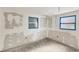 Bedroom with two windows, unfinished drywall, and flooring provides customization opportunities at 17 Southwind Dr, Englewood, FL 34223