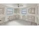 Bedroom with two windows, unfinished drywall, and flooring provides customization opportunities at 17 Southwind Dr, Englewood, FL 34223