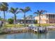 Charming waterfront home with mature palms, dock, and screened porch at 17 Southwind Dr, Englewood, FL 34223