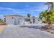 Charming single-story home featuring a spacious driveway, manicured landscaping, and a welcoming entrance at 17 Southwind Dr, Englewood, FL 34223
