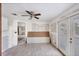 Open living room featuring tiled floors, fresh drywall, ceiling fan, and glass patio doors to outdoor space at 17 Southwind Dr, Englewood, FL 34223