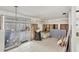 Living room featuring tile flooring, partially renovated walls, and access to sunroom at 17 Southwind Dr, Englewood, FL 34223