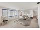 Partially renovated living room featuring tile flooring and a large window with backyard views at 17 Southwind Dr, Englewood, FL 34223