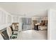 Living room showcasing tile flooring, partially renovated walls, and access to sunroom at 17 Southwind Dr, Englewood, FL 34223