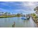 Picturesque waterfront canal with private dock, boat lift and lush tropical landscaping at 17 Southwind Dr, Englewood, FL 34223