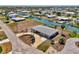 Aerial view of a canal front home featuring lush landscaping and boat dock at 1915 Illinois Ave, Englewood, FL 34224