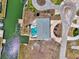 Aerial view of a home with a pool, dock, and waterfront access on a sunny day at 1915 Illinois Ave, Englewood, FL 34224