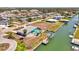 Stunning aerial view of a waterfront home featuring a private pool, boat dock, and waterfront access at 1915 Illinois Ave, Englewood, FL 34224